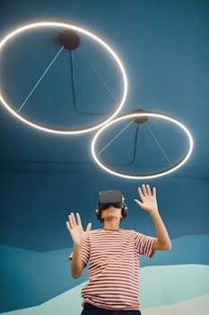 A young boy wearing VR headset interacting with virtual content in a modern room.