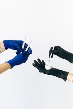 Close-up of gloved hands using beauty tools, focusing on careful application.