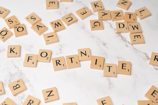 Scrabble tiles spelling Fortnite on a marble surface, ideal for gaming concept art.