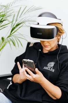 Woman engaged in virtual reality using a headset and smartphone in a cozy setting.